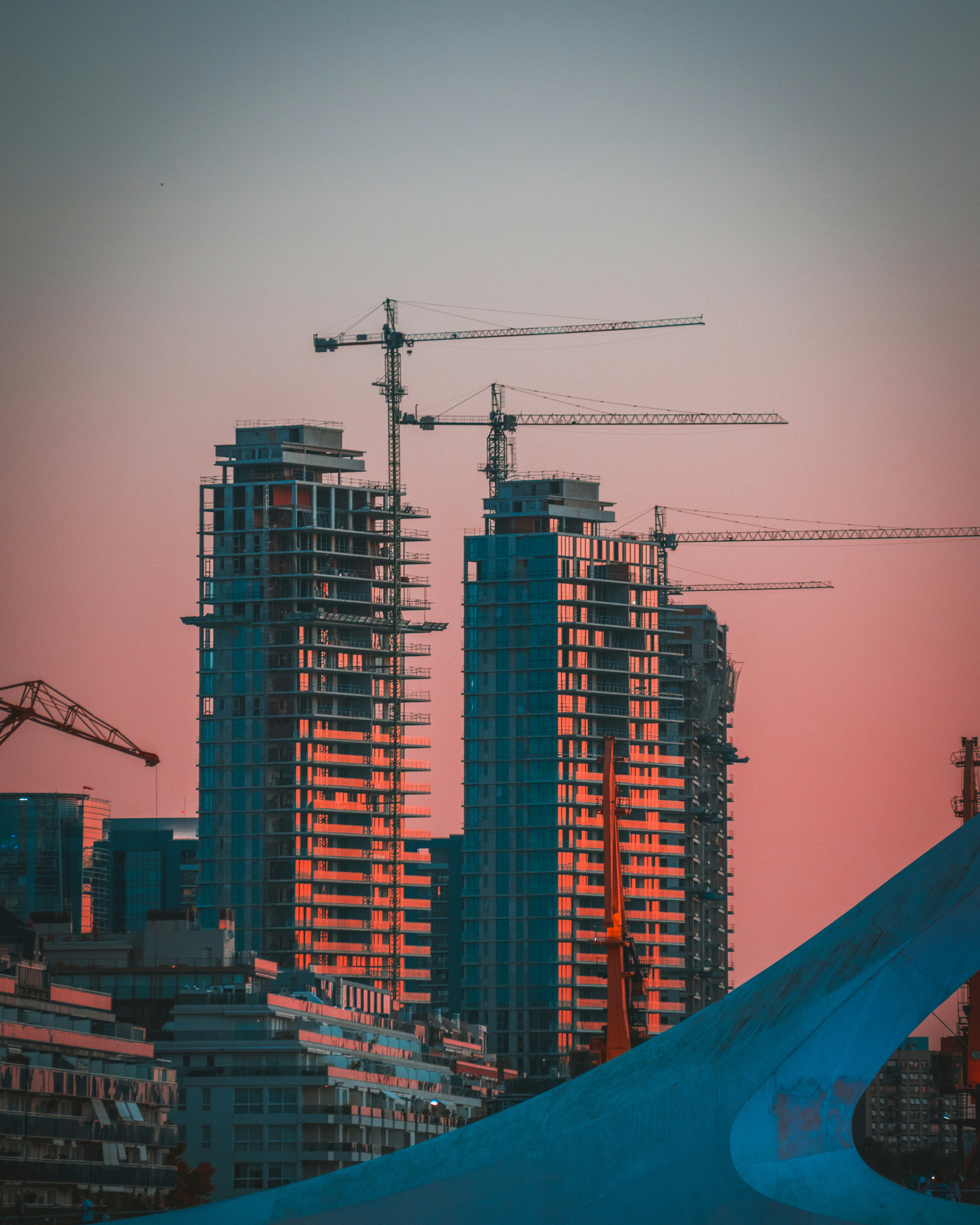 Construction cranes at dusk